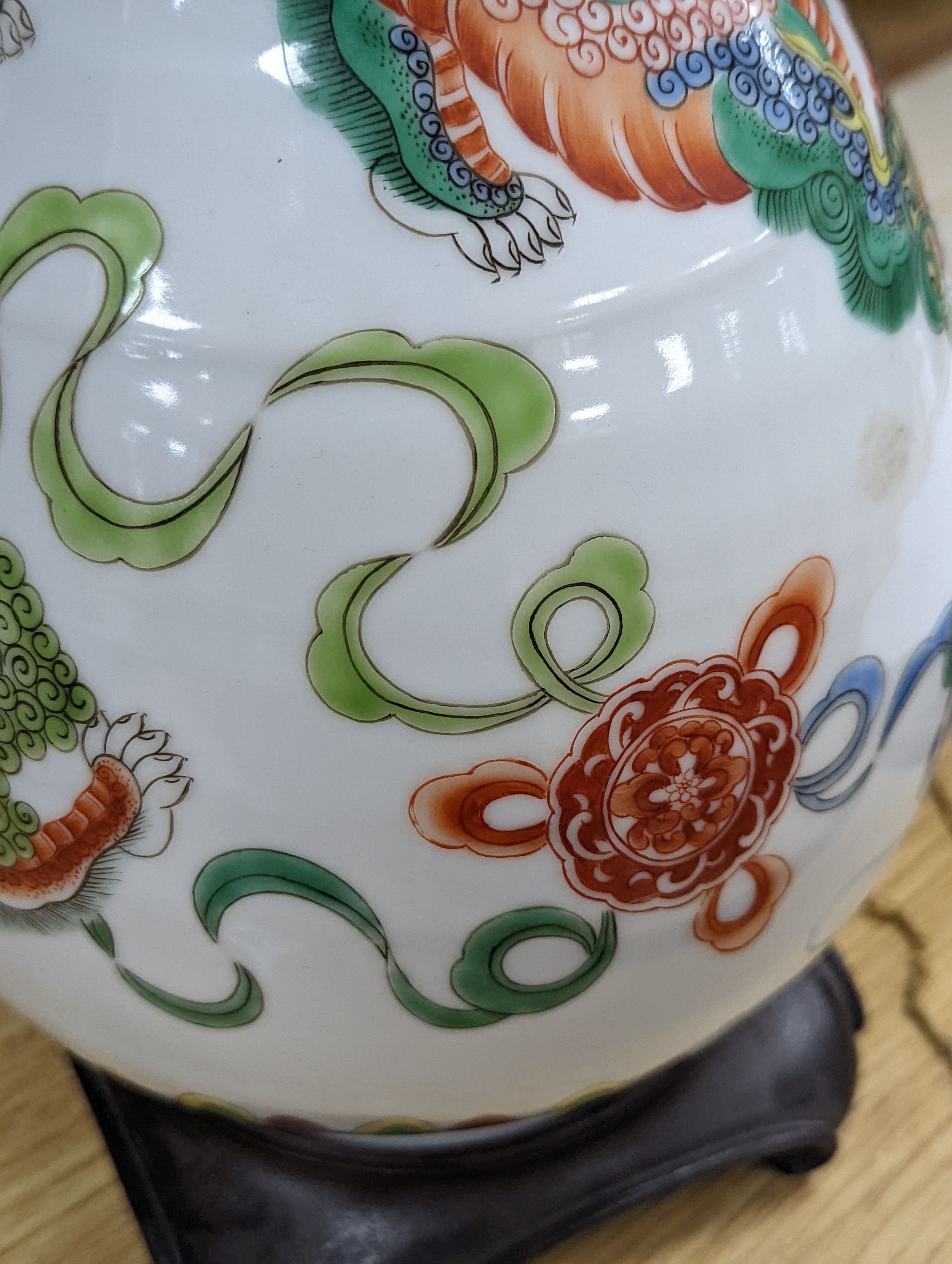 A Chinese famille verte pear shaped ‘Buddhist lion’ vase, on stand, 32 cms high not including stand.